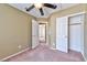 Comfortable bedroom with fan, closet, and view of another room at 6113 Breeders Cup St, Las Vegas, NV 89130