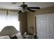 Bedroom with ceiling fan, window with curtains, and sliding door to closet at 6113 Breeders Cup St, Las Vegas, NV 89130