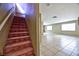 Spacious home entryway features stairs, tile floors, and neutral colors, providing a welcoming atmosphere at 6113 Breeders Cup St, Las Vegas, NV 89130