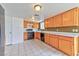 Kitchen area featuring tile flooring and wooden cabinets at 6113 Breeders Cup St, Las Vegas, NV 89130