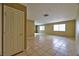 Bright and airy living room boasts neutral paint, tile flooring, and ample natural light through large windows at 6113 Breeders Cup St, Las Vegas, NV 89130