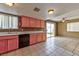 View from kitchen area to living room area with sliding doors to outdoor space at 6113 Breeders Cup St, Las Vegas, NV 89130