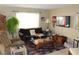 Living room with brown sofa, recliner, and flat-screen TV at 6113 Breeders Cup St, Las Vegas, NV 89130