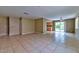 Open-concept living room features tile flooring, neutral paint, and sliding door access to the backyard at 6113 Breeders Cup St, Las Vegas, NV 89130