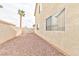 Side yard with gravel cover and stucco wall, offering low-maintenance appeal at 6113 Breeders Cup St, Las Vegas, NV 89130