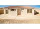 Backyard view of the home, showcasing a large patio and desert landscaping at 6230 Home Haven St, North Las Vegas, NV 89031