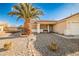 Landscaped front yard with a palm tree and gravel at 6230 Home Haven St, North Las Vegas, NV 89031