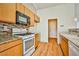 Kitchen with wood cabinets and a gas stove at 6230 Home Haven St, North Las Vegas, NV 89031