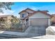 Two-story house with Spanish tile roof, wrought iron fence, and attached two-car garage at 6233 Morning Splendor Way, Las Vegas, NV 89110