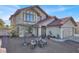 Two-story house with a red tile roof, light-colored exterior, and landscaping at 6233 Morning Splendor Way, Las Vegas, NV 89110