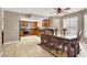 Open concept kitchen and dining area with tile flooring and wood cabinets at 6233 Morning Splendor Way, Las Vegas, NV 89110