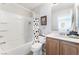 Clean bathroom with tub shower, wood vanity, and decorative shower curtain at 6255 W Arby Ave # 218, Las Vegas, NV 89118