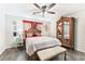 Spacious bedroom with large bed, wooden armoire, and ceiling fan at 6255 W Arby Ave # 218, Las Vegas, NV 89118