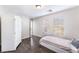 Bright bedroom with dark hardwood floors and a white armoire at 6255 W Arby Ave # 218, Las Vegas, NV 89118