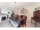 Bright dining room with a wooden table and view into kitchen at 6255 W Arby Ave # 218, Las Vegas, NV 89118