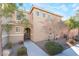 Two-story house with light brown exterior, landscaping, and walkway at 6255 W Arby Ave # 218, Las Vegas, NV 89118