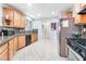 Modern kitchen with wood cabinets and stainless steel appliances at 6255 W Arby Ave # 218, Las Vegas, NV 89118