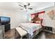 Main bedroom with dark hardwood floors and a large bed at 6255 W Arby Ave # 218, Las Vegas, NV 89118