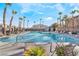 Community pool with lounge chairs and palm trees at 6255 W Arby Ave # 218, Las Vegas, NV 89118