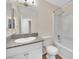 Bathroom with granite countertop, white cabinets and bathtub at 6436 Whippoorwill Way, Las Vegas, NV 89103