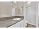 Bathroom with granite countertop, white cabinets and shower at 6436 Whippoorwill Way, Las Vegas, NV 89103