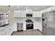 Modern kitchen featuring white cabinets, stainless steel appliances, and quartz countertops at 6436 Whippoorwill Way, Las Vegas, NV 89103