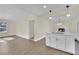 Open concept kitchen with island, white cabinets and hardwood floors at 6436 Whippoorwill Way, Las Vegas, NV 89103