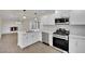 Modern kitchen with white shaker cabinets, stainless steel appliances, and quartz countertops at 6436 Whippoorwill Way, Las Vegas, NV 89103