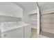 Clean laundry room with washer, dryer and shelving at 6436 Whippoorwill Way, Las Vegas, NV 89103