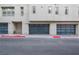 Two-car garage with glass panels and paver driveway at 650 Sentinel Spire St, Las Vegas, NV 89138