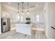 Modern kitchen with white cabinets, quartz island, and stainless steel appliances at 650 Sentinel Spire St, Las Vegas, NV 89138