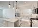 Modern kitchen with white cabinets, island, and stainless steel appliances at 650 Sentinel Spire St, Las Vegas, NV 89138