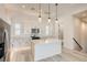 Modern kitchen with white cabinets, quartz island, and stainless steel appliances at 650 Sentinel Spire St, Las Vegas, NV 89138