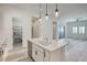 Modern kitchen with white cabinets, island, and stainless steel appliances at 650 Sentinel Spire St, Las Vegas, NV 89138