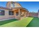 Covered patio, artificial turf, and built-in BBQ at 6819 Rolling Boulder St, Las Vegas, NV 89149