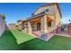 House with covered patio, artificial turf and playset at 6819 Rolling Boulder St, Las Vegas, NV 89149