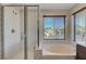 Clean bathroom with a shower and bathtub at 6819 Rolling Boulder St, Las Vegas, NV 89149