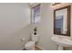 Clean bathroom with toilet, sink, and framed mirror at 6819 Rolling Boulder St, Las Vegas, NV 89149