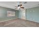 Bright bedroom featuring a large window and ceiling fan at 6819 Rolling Boulder St, Las Vegas, NV 89149