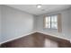 Empty bedroom featuring wood floors and a large window at 6819 Rolling Boulder St, Las Vegas, NV 89149