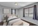 Well-lit bedroom with dark hardwood floors and window coverings at 6819 Rolling Boulder St, Las Vegas, NV 89149