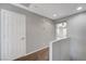 Upstairs hallway with carpet and doors to bedrooms at 6819 Rolling Boulder St, Las Vegas, NV 89149