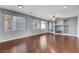 Spacious living room featuring hardwood floors, built-in shelving, and large windows at 6819 Rolling Boulder St, Las Vegas, NV 89149