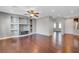 Living room with hardwood floors, built-in shelving and a ceiling fan at 6819 Rolling Boulder St, Las Vegas, NV 89149