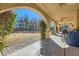 Covered patio with arches, overlooking the grassy backyard at 6901 Copper Kettle Ave, Las Vegas, NV 89130