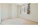 Simple carpeted bedroom with large window and closet at 6901 Copper Kettle Ave, Las Vegas, NV 89130