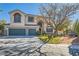 Two-story house with a landscaped yard, two-car garage, and gated entry at 6901 Copper Kettle Ave, Las Vegas, NV 89130