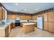 Kitchen with light wood cabinets, island, and tile flooring at 6901 Copper Kettle Ave, Las Vegas, NV 89130