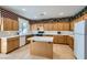 Kitchen with light wood cabinets, island, and tile flooring at 6901 Copper Kettle Ave, Las Vegas, NV 89130