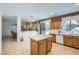 Kitchen with light wood cabinets, island, and sliding door to backyard at 6901 Copper Kettle Ave, Las Vegas, NV 89130